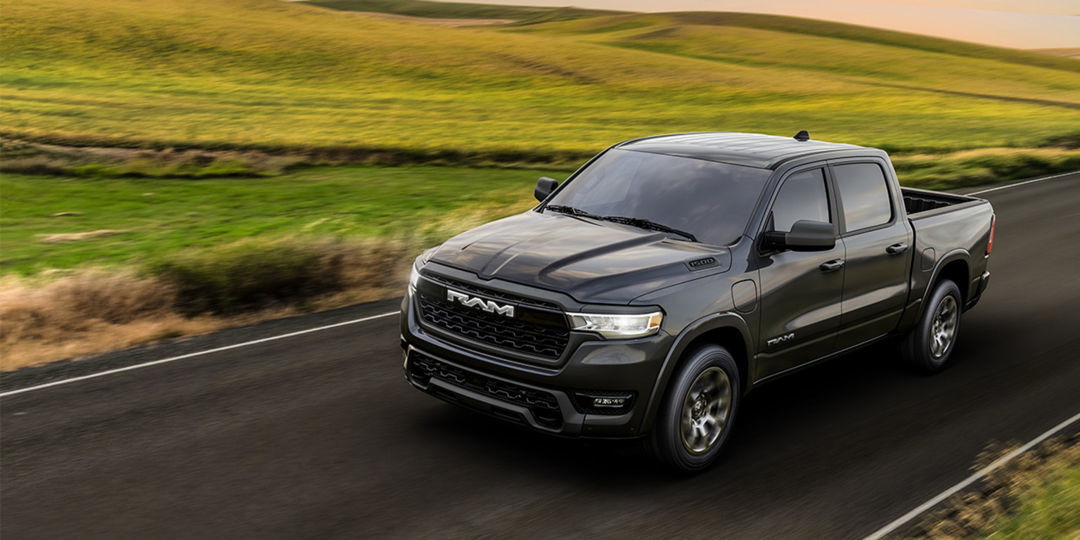 RAMCHARGER rolling on asphalt with meadow background