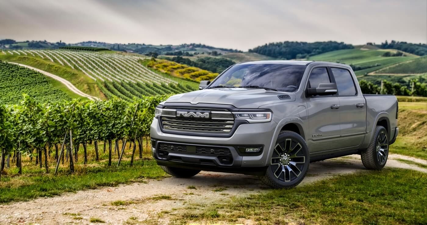 Front 3/4 view of the 2025 RAM 1500 parked in a field.