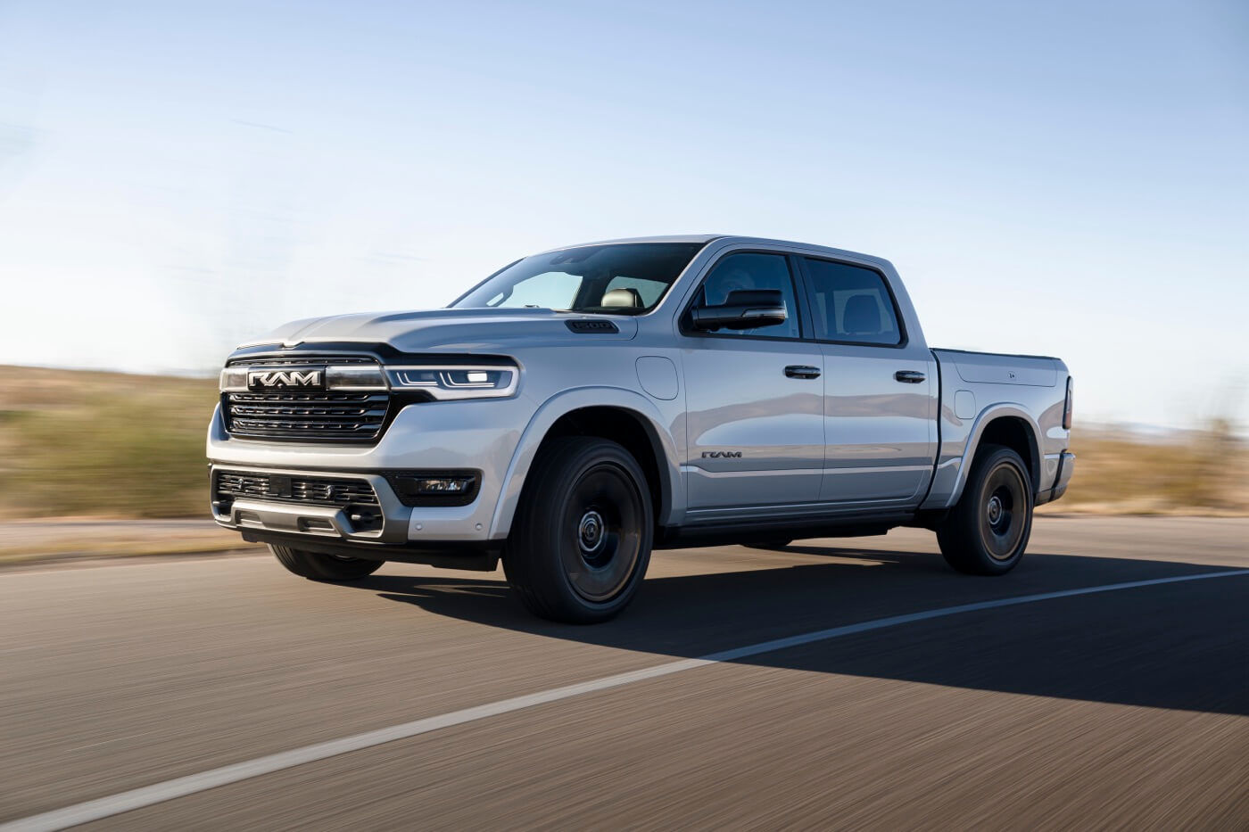 Front 3/4 view of the 2025 RAM 1500 on the road.