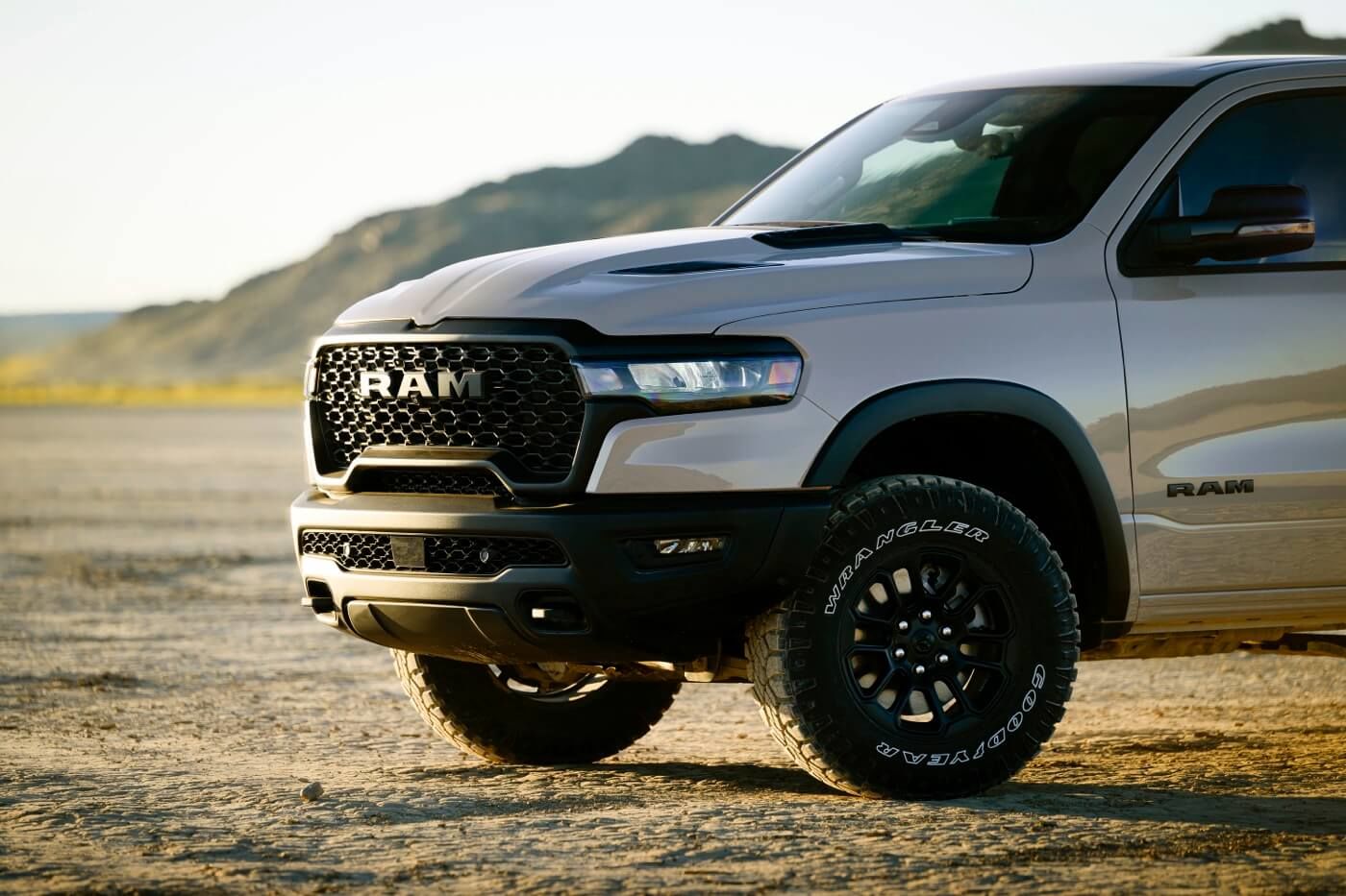 Front 3/4 view of 2025 RAM 1500 parked on rock.