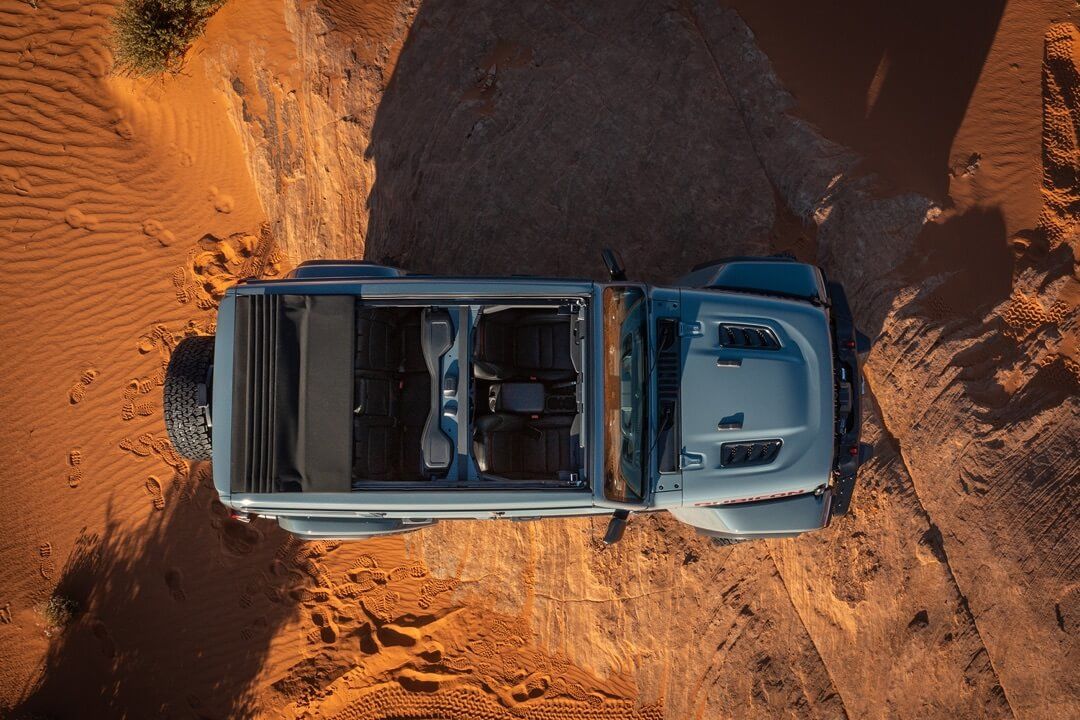 A bird's eye view of the 2024 Jeep Wrangler with its retractable roof open.