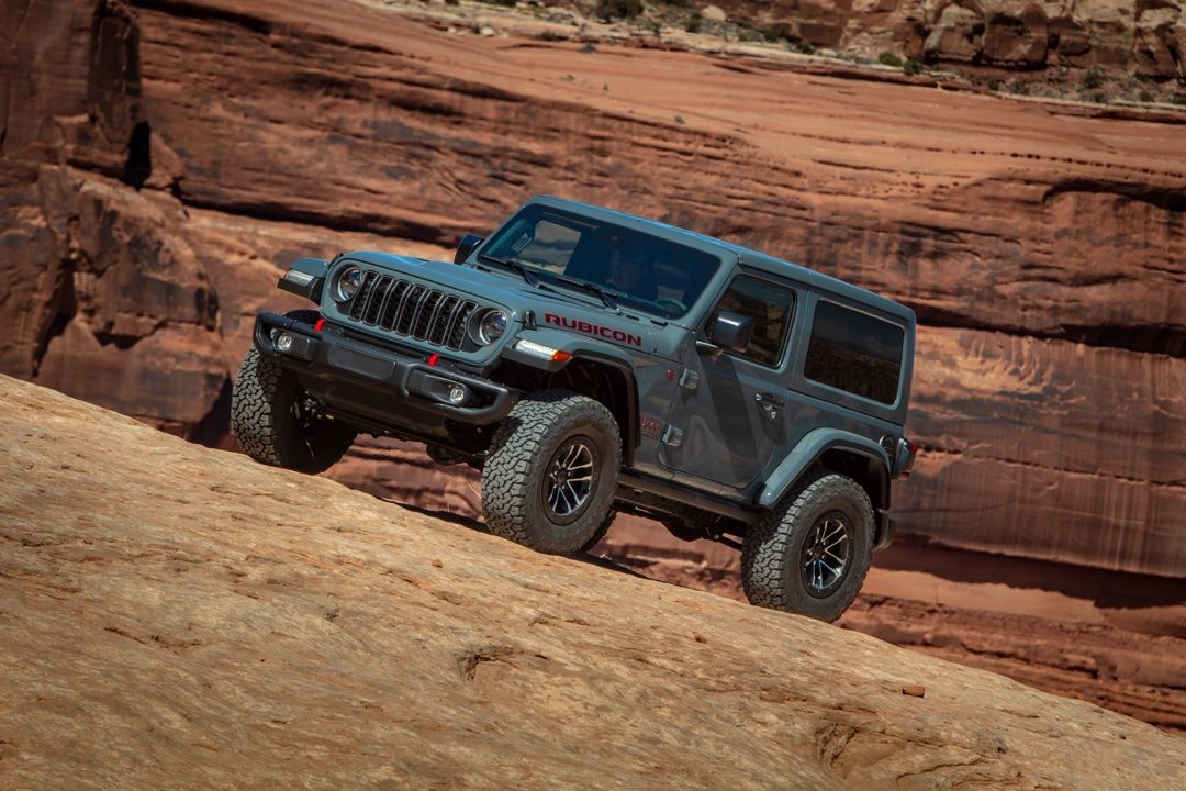 3/4 front view of 2025 Jeep Wrangler parked in a desert.