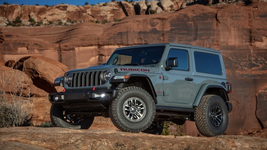 The 2025 Jeep Wrangler, parked atop a hill, standing tall and ready for adventure.