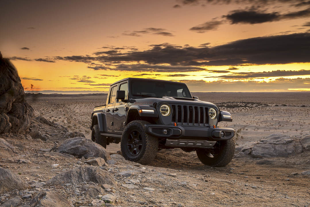 3/4 front view of a Jeep Gladiator Mojave truck parked in a desert.