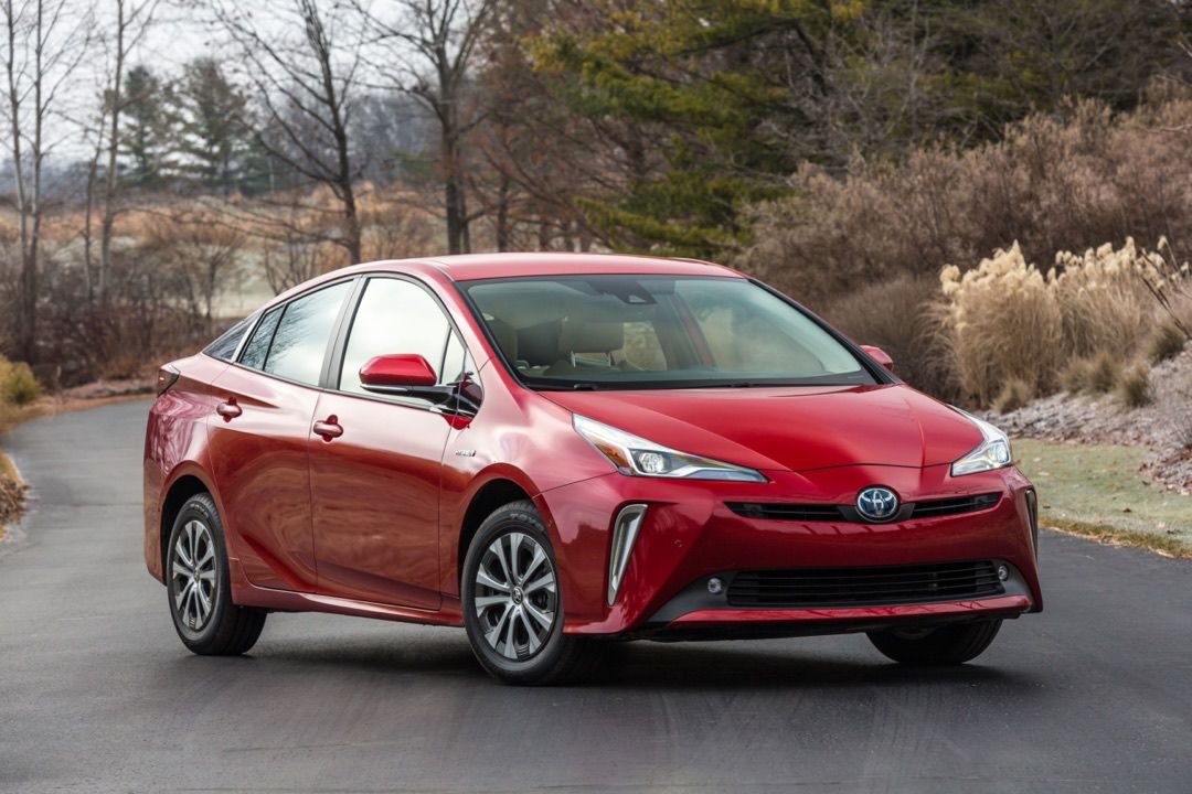 front 3/4 view of red 2019 Toyota Prius XLE SUV parked on a road