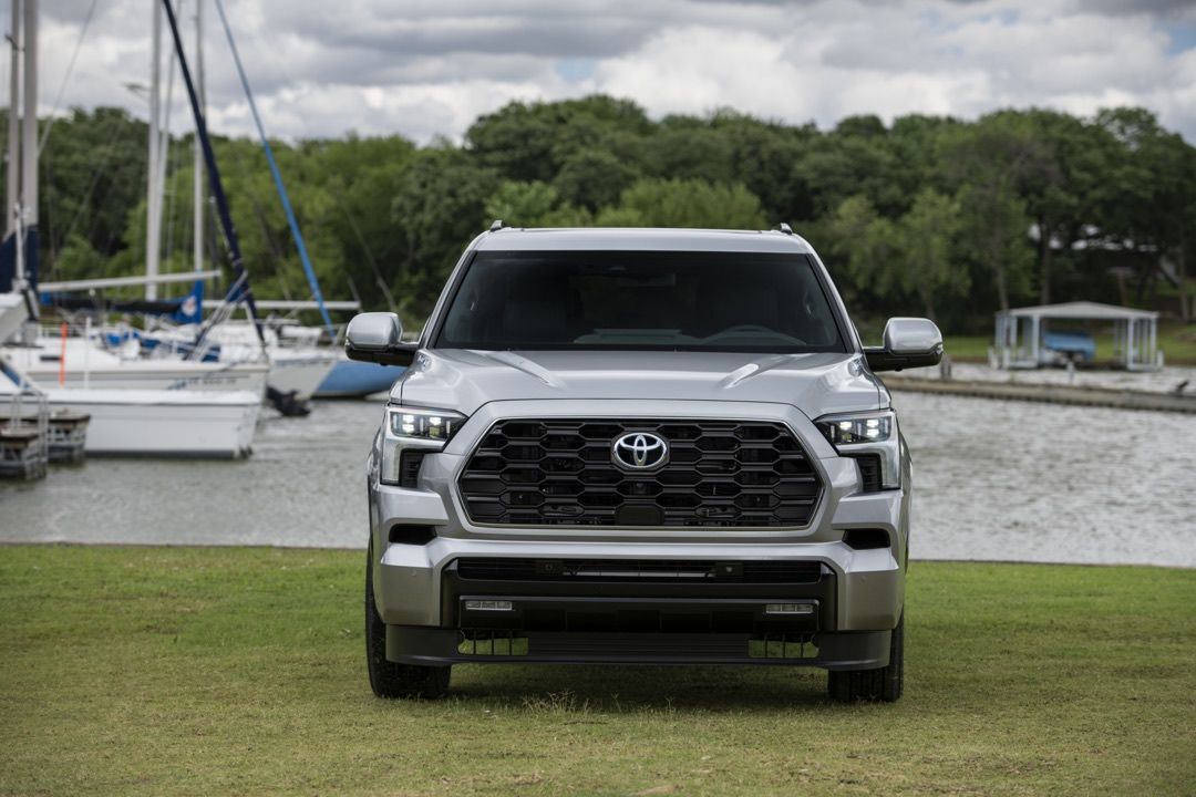 front view of a new 2023 Toyota Sequoia Platinum truck parked in a field