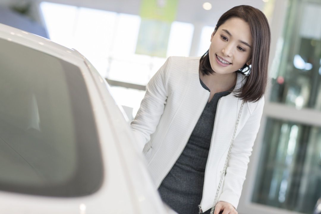 woman shopping for a new car at a dealership