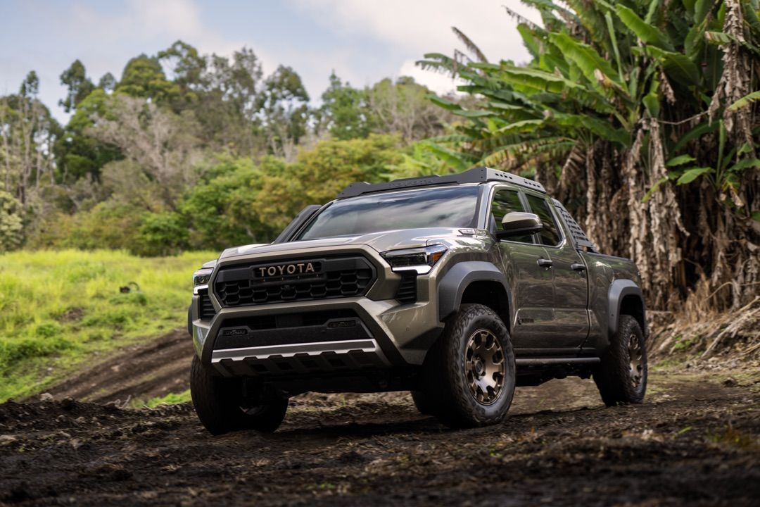 Front 3/4 view of the 2024 Toyota Tacoma Trailhunter parked on dirt.