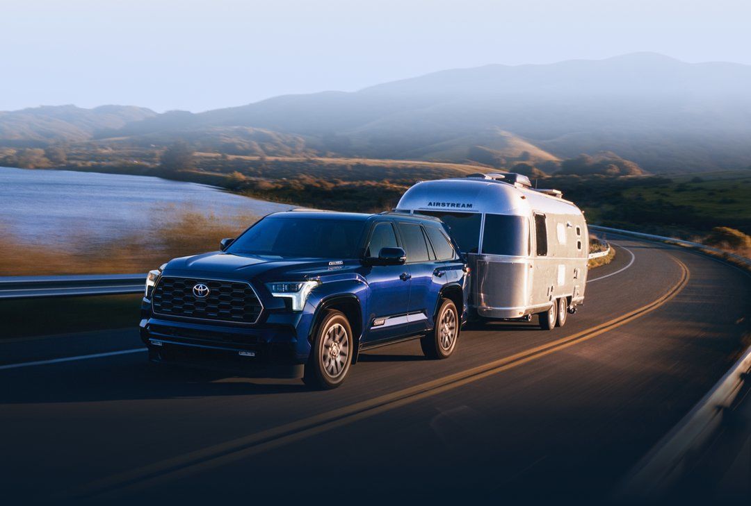 A Toyota Sequoia 2024 towing an Airstream trailer.