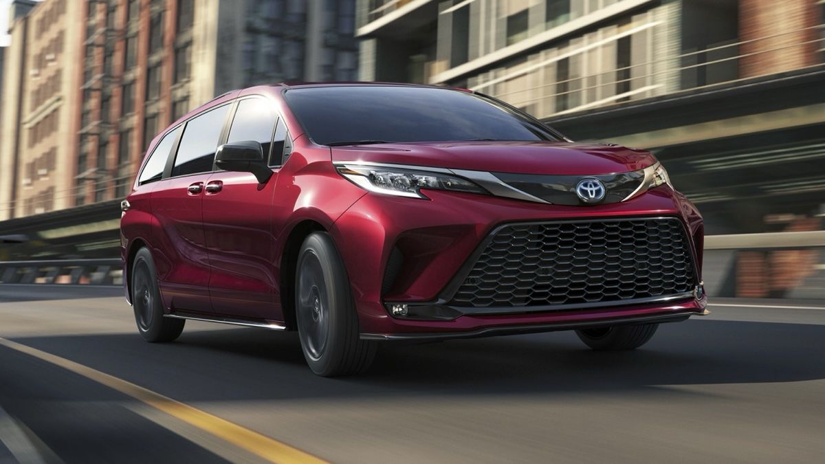 Close-up view of the front end of the Toyota Sienna 2024 driving around town.