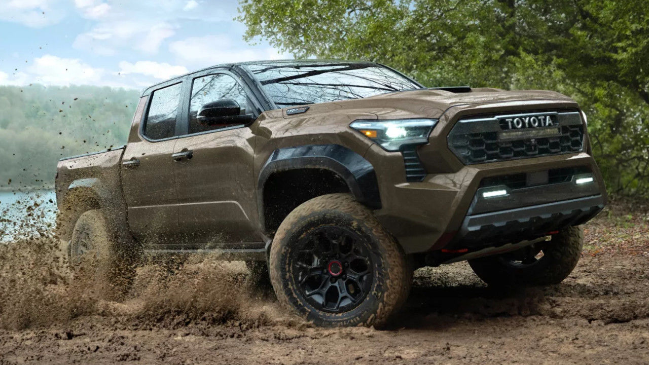 front side view of a 2025 Toyota Tacoma crossing a mud puddle