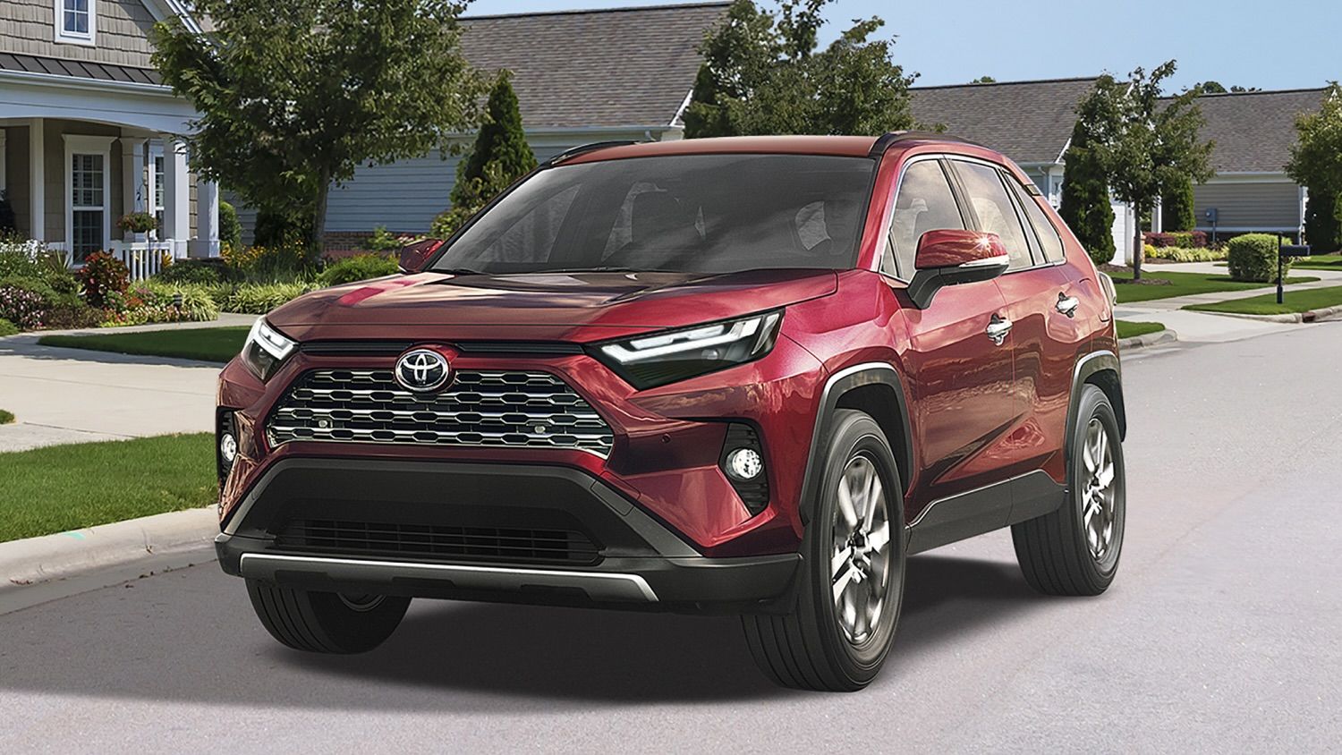 The Toyota RAV4 driving in a residential neighborhood.