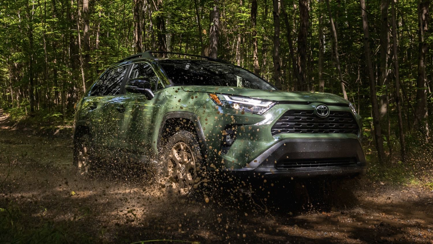 The Toyota RAV4 skidding on a dirt road in the forest.