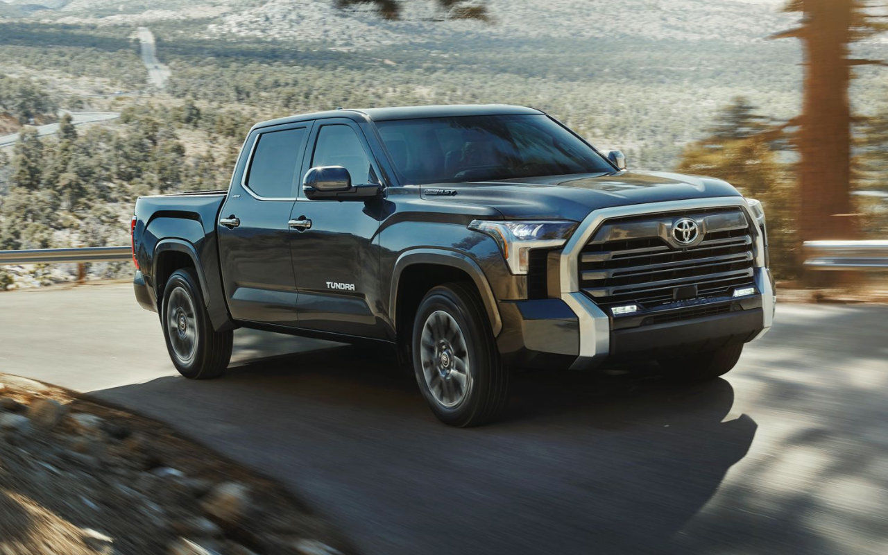 Front 3/4 view of the 2023 Toyota Tundra driving on a road.