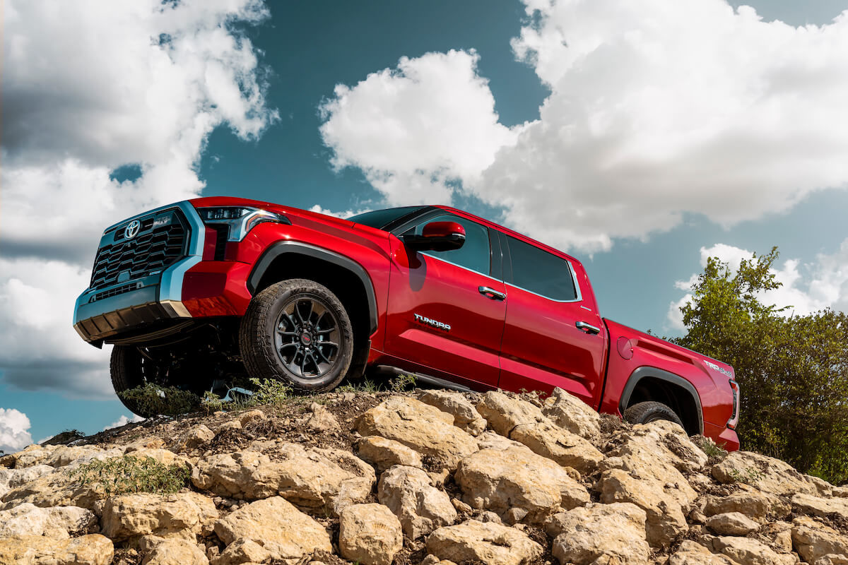 The 2022 Toyota Tundra Limited parked on a mound of rocks pointing to the sky