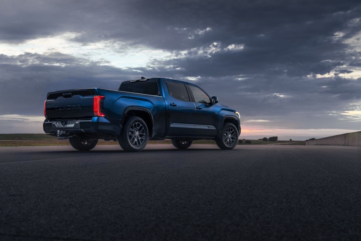 Rear 3/4 view of 2022 Toyota Tundra Platinum outdoors during sunset time