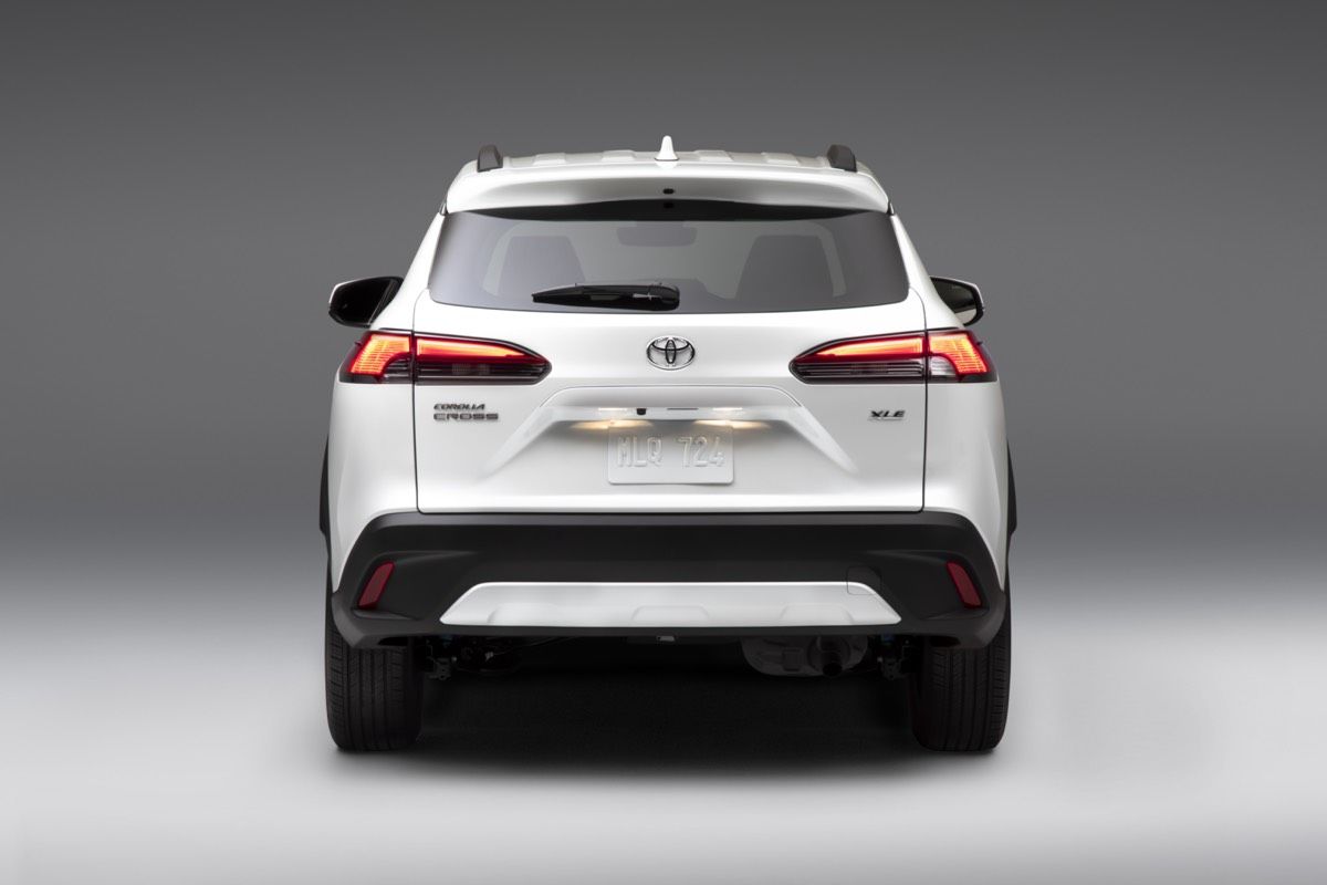 Rear view of the 2022 Toyota Corolla Cross Wind Chill Pearl against a gray background