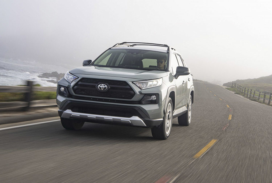 The Lunar rock 2021 Toyota RAV4 driving on a big road by the sea