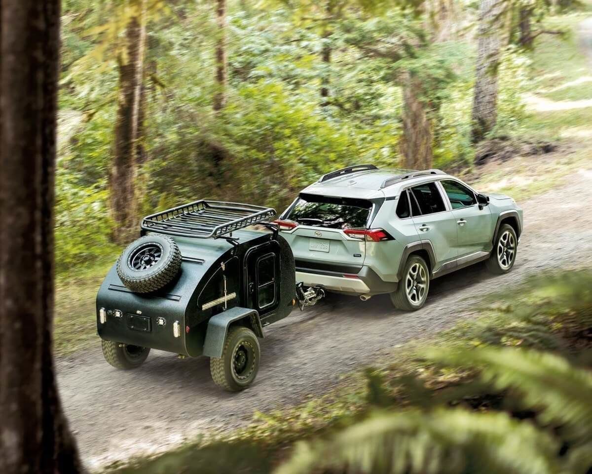 The 2021 Toyota RAV4 towing a mini-trailer in the forest