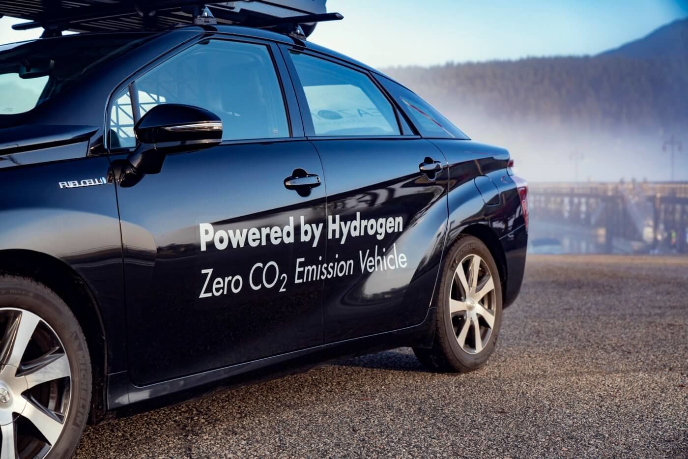 Powered by Hydrogen Zero CO2 Emission Vehicle printed on the side of a Toyota Mirai
