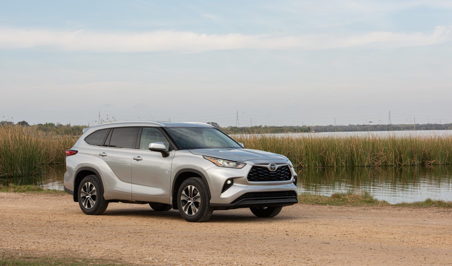 2020 Toyota Highlander - a silver 2020 Toyota Highlander parked next to water - AutoPark Barrie pre-owned car dealer in Innisfil, Ontario