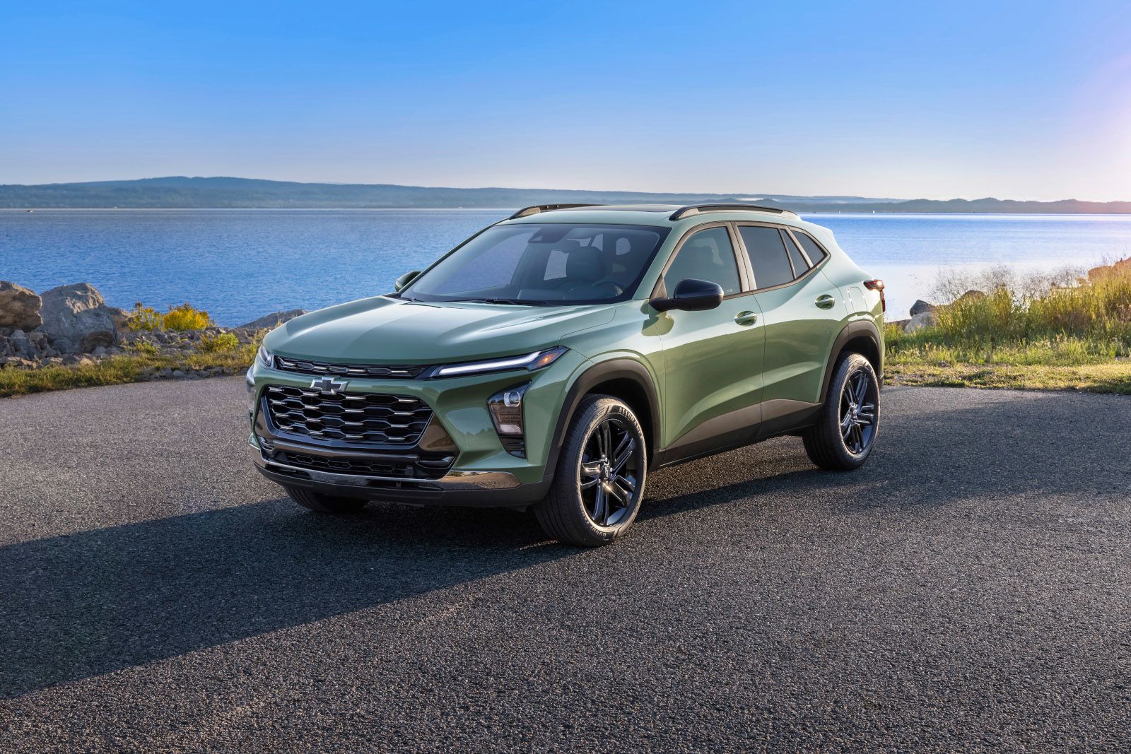 2025 Chevrolet Trax Front three-quarter view of a green Chevrolet Trax Activ parked by the water - Applewood Chevrolet, Buick, GMC - new car dealerships in Ontario