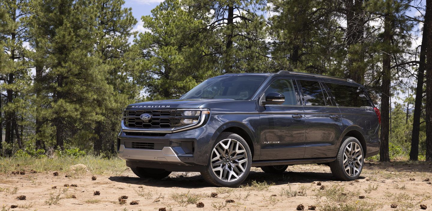 2025 Ford Expedition - front three-quarter view of a dark blue 2025 Ford Expedition parked in a forest - Bayfield Ford - Ford car dealership in Barrie, ON