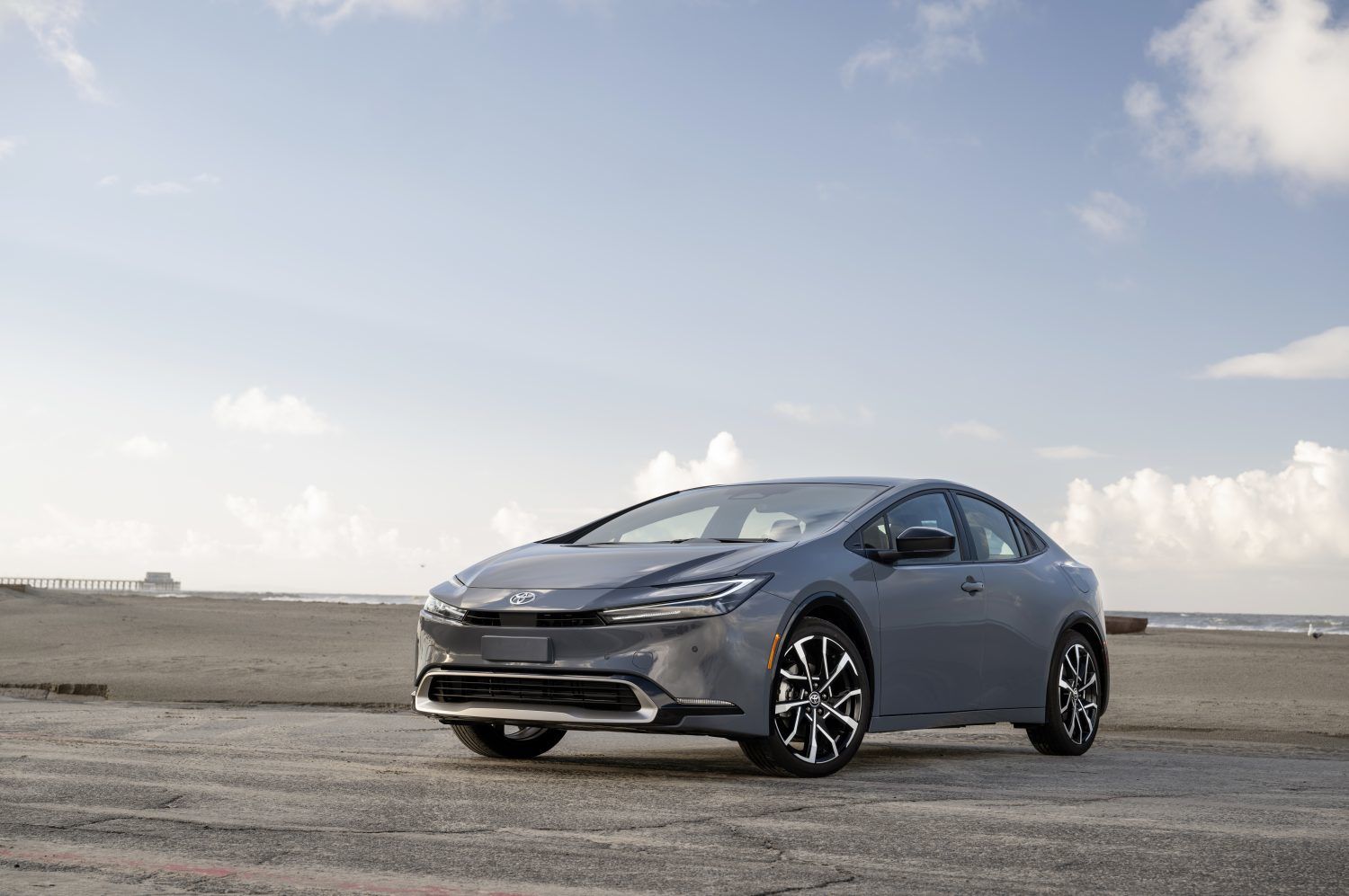 2025 Toyota Prius Prime - front-view of a grey 2025 Toyota Prius Prime parked by the beach - Orangeville Toyota - Toyota car dealership in Orangeville, ON