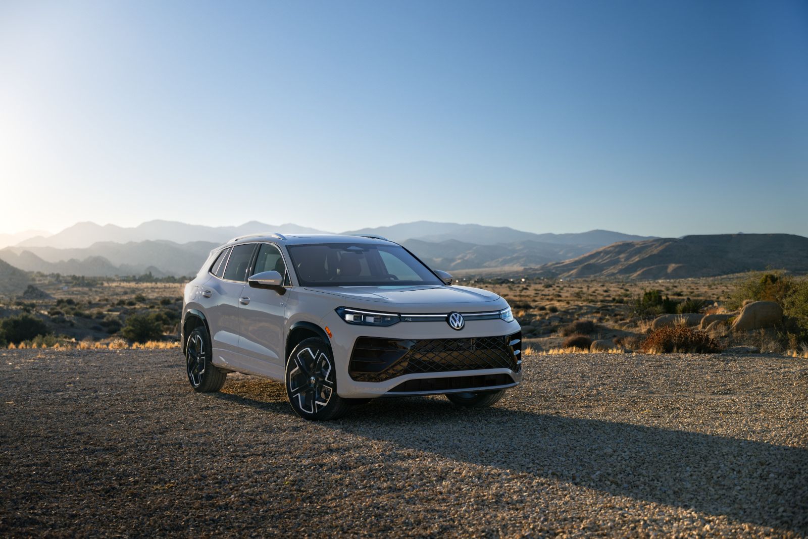 2025 Volkswagen Tiguan front view of a light grey Volkswagen Tiguan parked on a gravel road in a desert landscape - Humberview Volkswagen - new car dealerships in Ontario