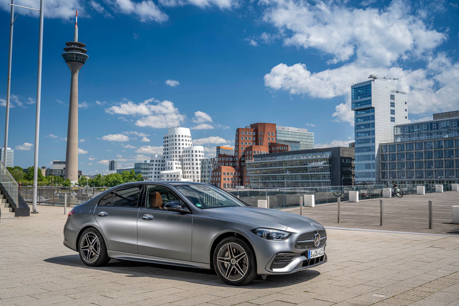 2025 Mercedes-Benz C-Class - A silver sedan parked in a modern city - Mercedes-Benz Brampton - New car dealership in Toronto, Ontario