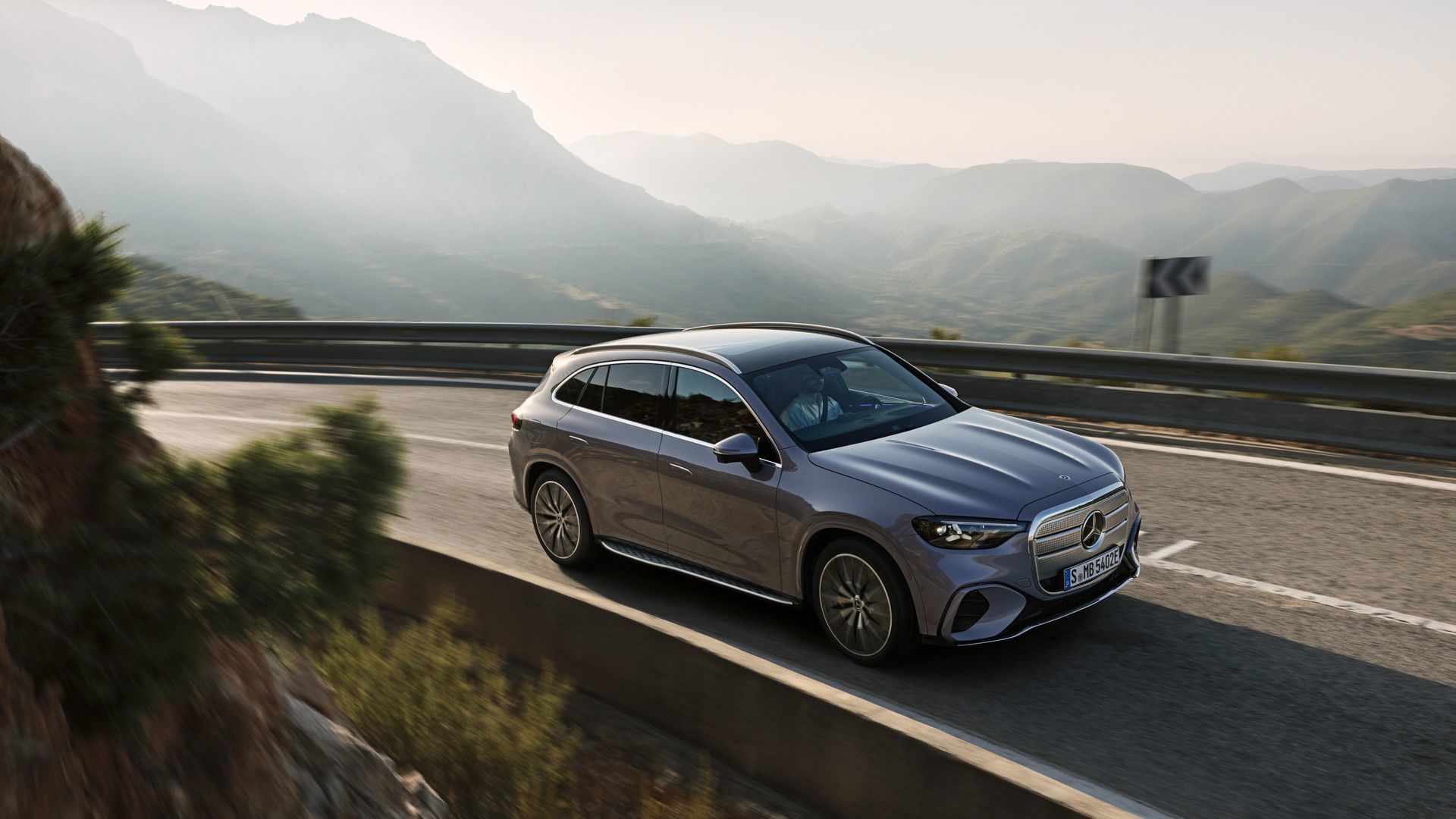 2026 Mercedes-Benz GLC with EQ Technology - Front view of the grey SUV driving along a mountain highway - Mercedes-Benz Brampton - New car dealership in Brampton, Ontario