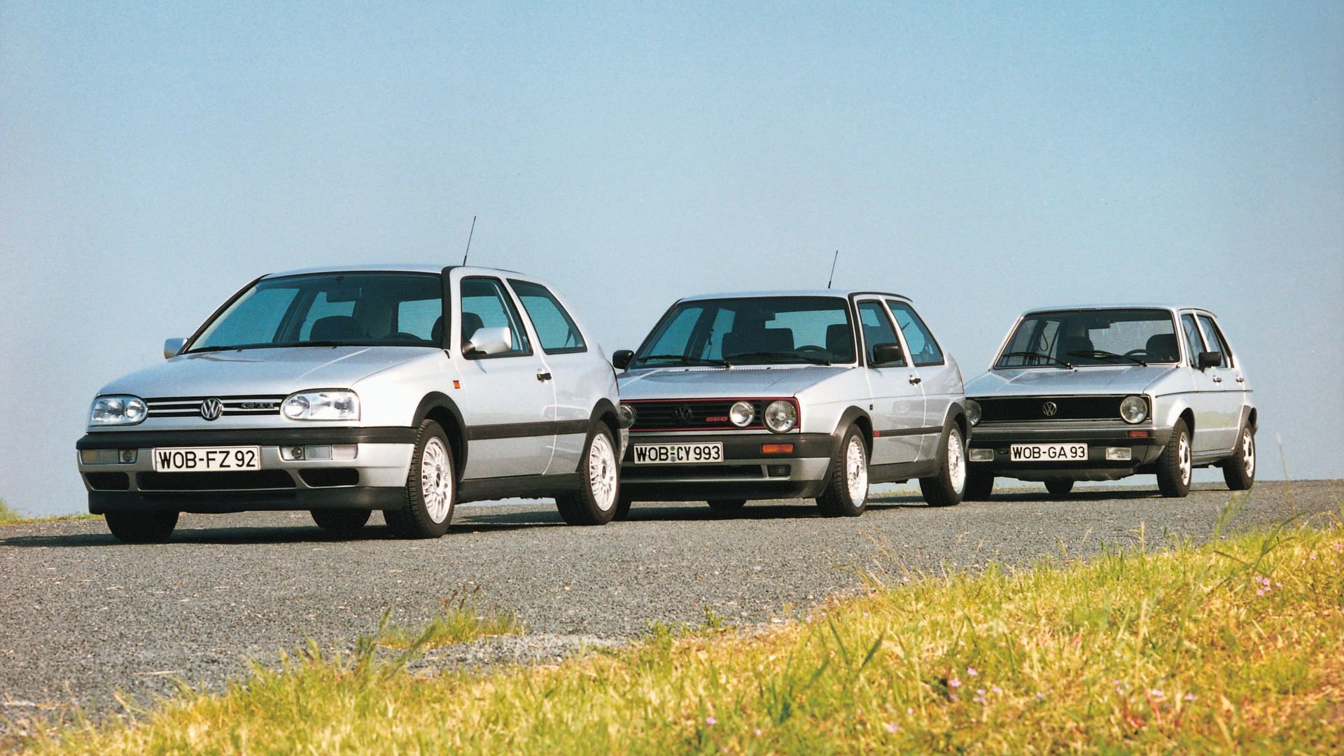 Volkswagen Golf - Three generations of the classic Volkswagen Golf parked in a line on a paved road - Volkswagen MidTown Toronto - New car dealership in Toronto, Ontario