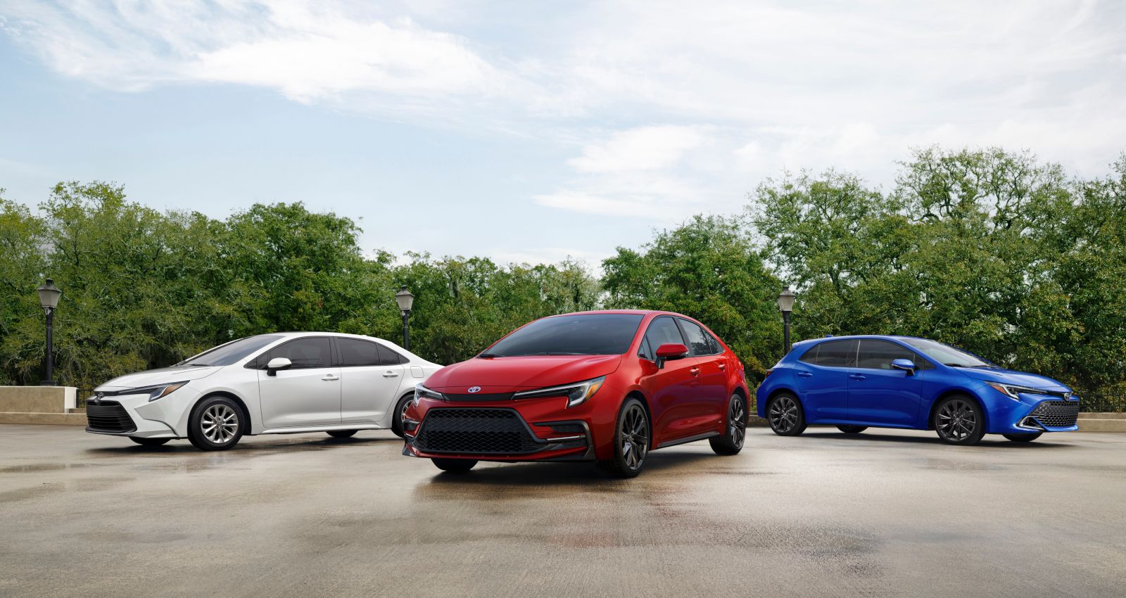 2026 Toyota Corolla Family - front view of the 2026 Toyota Corolla sedan, hybrid, and hatchback models parked together - Goderich Toyota - Toyota new car dealership in Goderich, Ontario