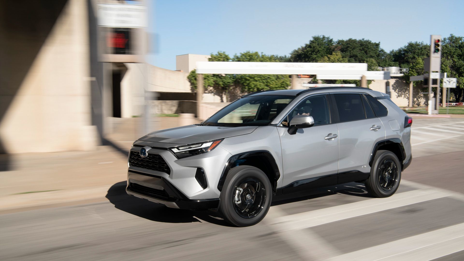 Toyota RAV4 - Silver Toyota RAV4 driving on a city street - AutoPark Barrie - Pre-owned car dealership in Innisfil, Ontario