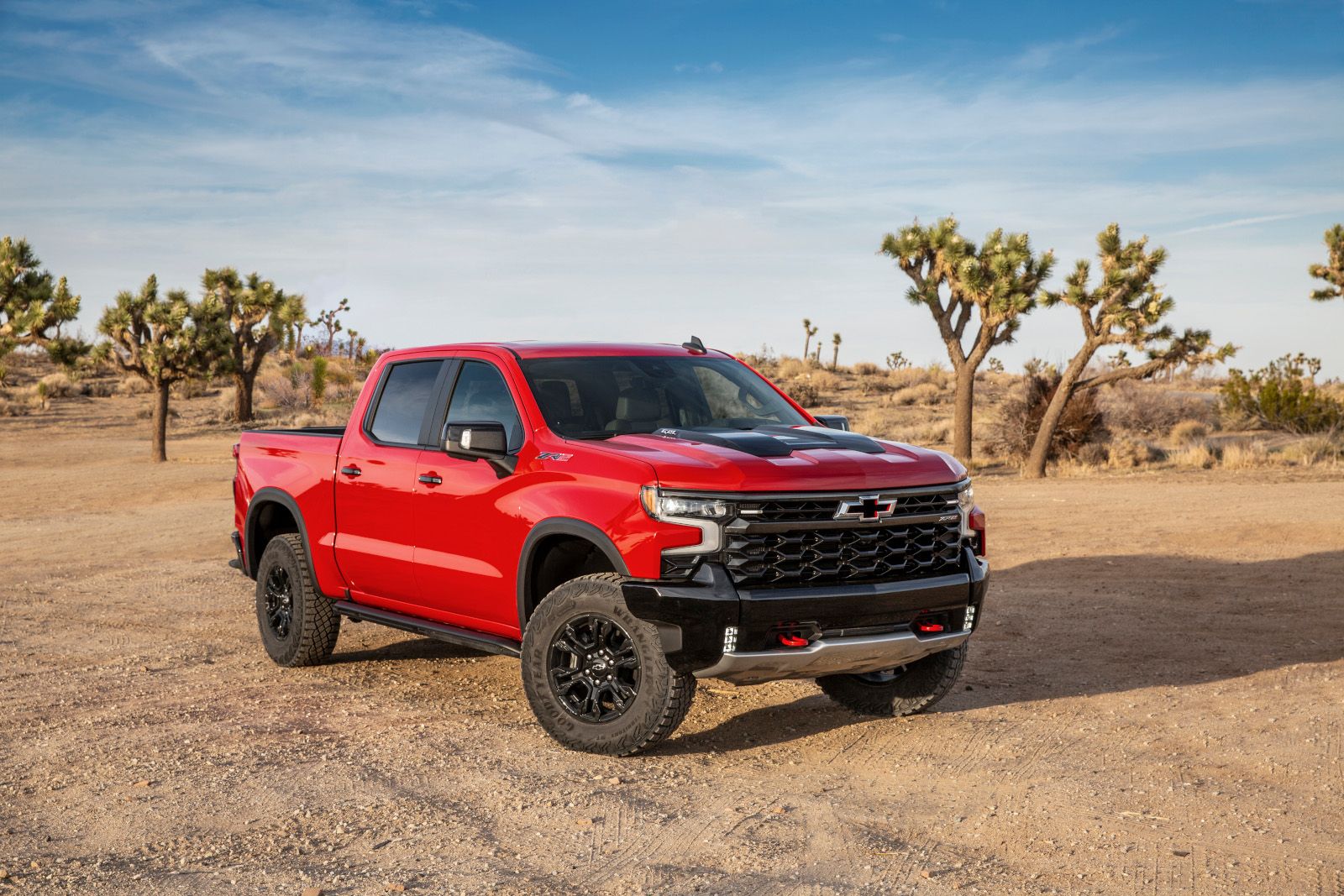 2026 Chevrolet Silverado ZR2 - front view of a red truck parked on a dirt trail.