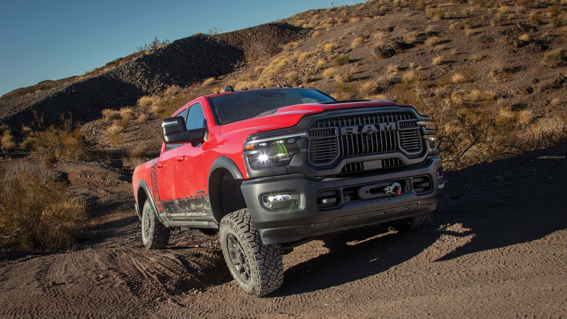 2026 Ram 2500 Power Wagon - front view of a red 2026 Ram 2500 Power Wagon driving on an off-road trail - Cooksville Chrysler, Jeep, Dodge, Ram - New car dealership in Mississauga, Ontario