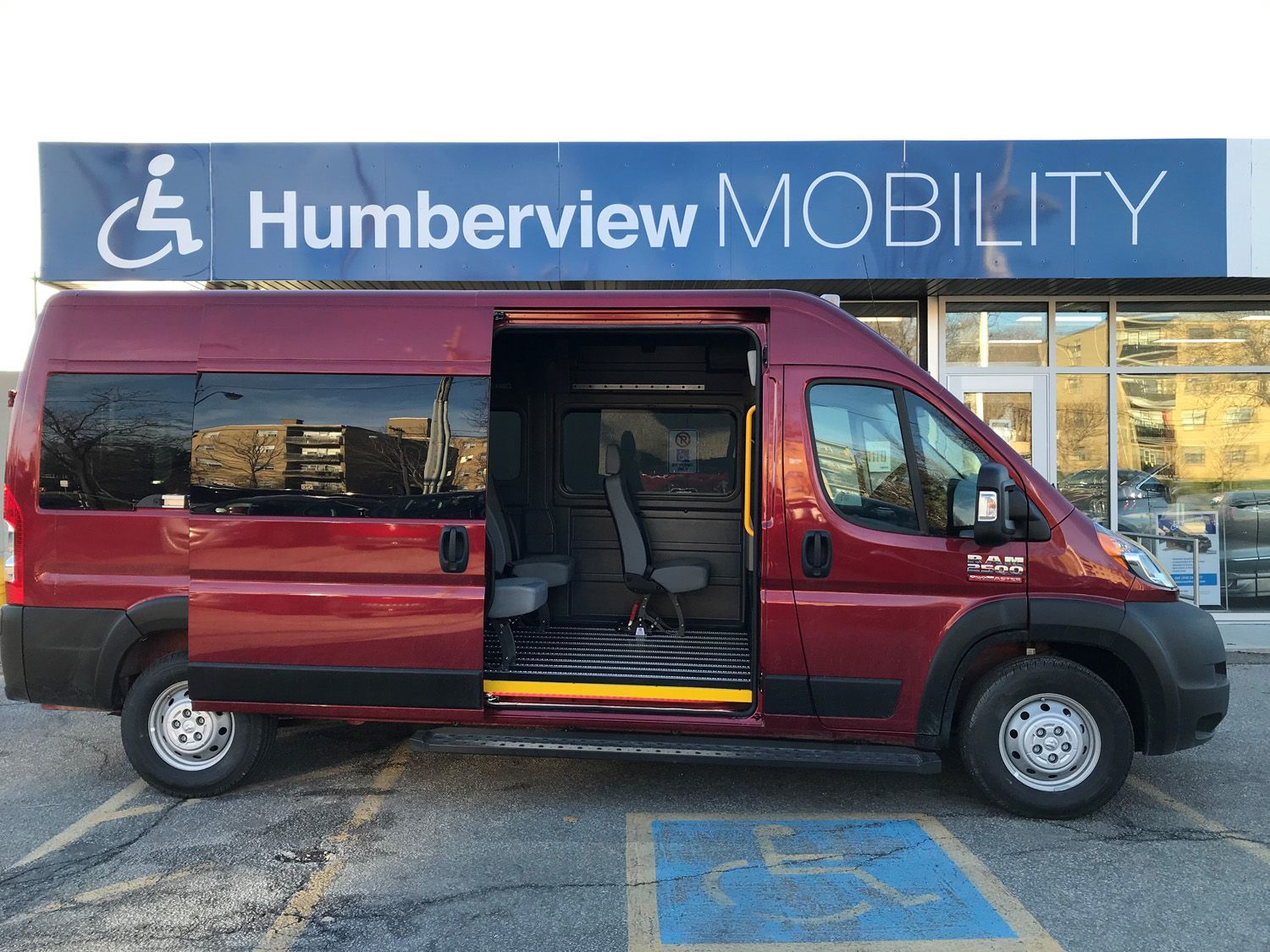 2026 Ram ProMaster - side view of a red 2026 Ram ProMaster mobility van with the sliding door open - Humberview Mobility - Accessible car dealership in Toronto, Ontario