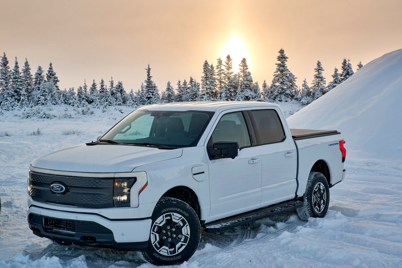 2026 Ford F-150 Lightning - a white Ford F-150 Lightning parked in a snowy winter landscape - Humberview Group - New car dealerships in Ontario