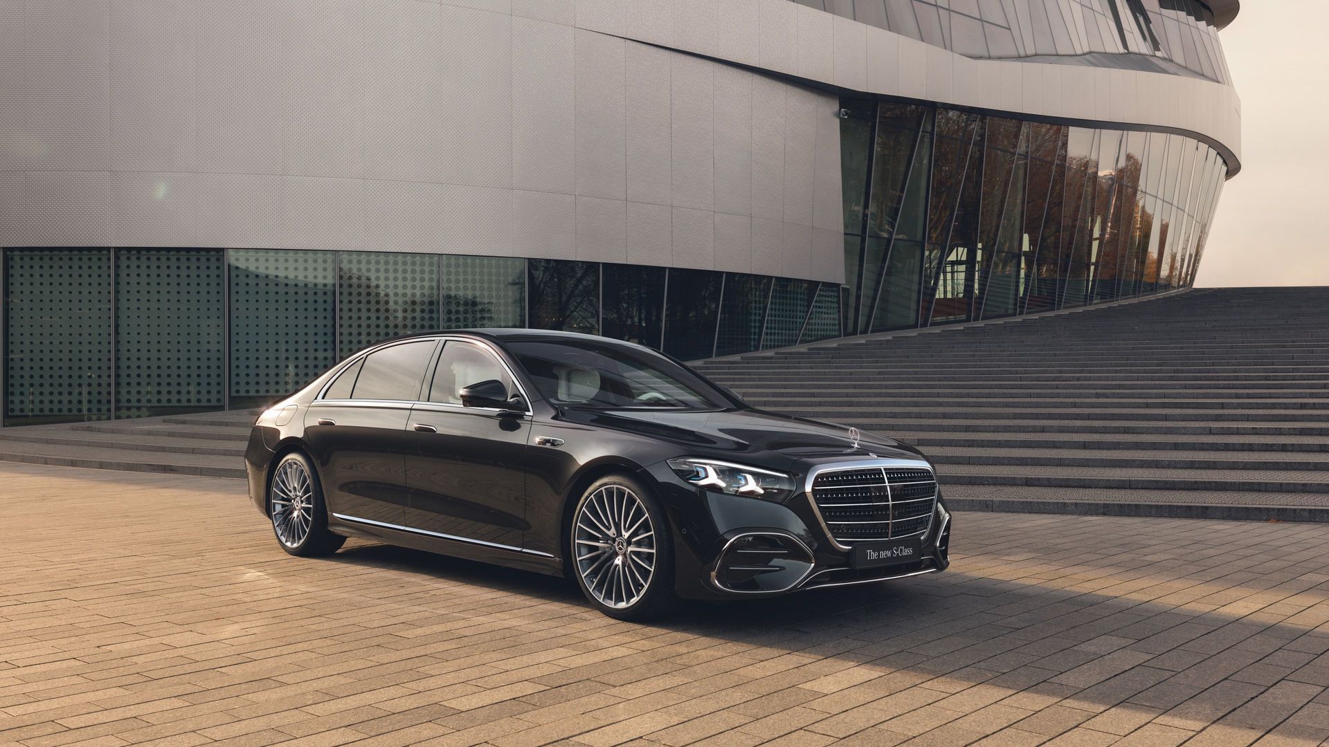 2026 Mercedes-Benz S-Class - front three-quarter view of a black 2026 Mercedes-Benz S-Class parked in front of a modern building - Mercedes-Benz Brampton - New car dealership in Brampton, Ontario