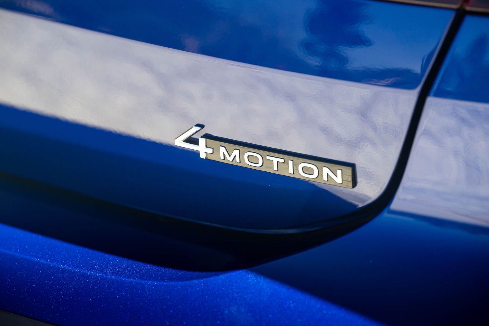 Close-up of the chrome 4MOTION badge on the rear of a blue Volkswagen - Volkswagen MidTown Toronto - Volkswagen new car dealership in Toronto, Ontario