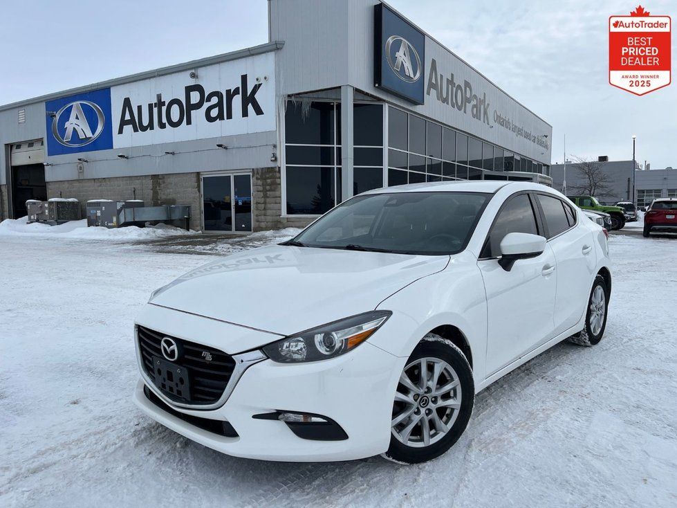 2018 Mazda Mazda3 - a white 2018 Mazda Mazda3 sedan parked in a snowy lot in front of the dealership - Autopark Brampton - Used car dealership in Brampton, Ontario