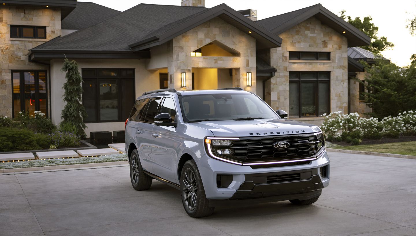 2026 Ford Expedition - A light blue Ford Expedition parked in front of a modern stone house - Humberview Group - new car dealerships in Ontario