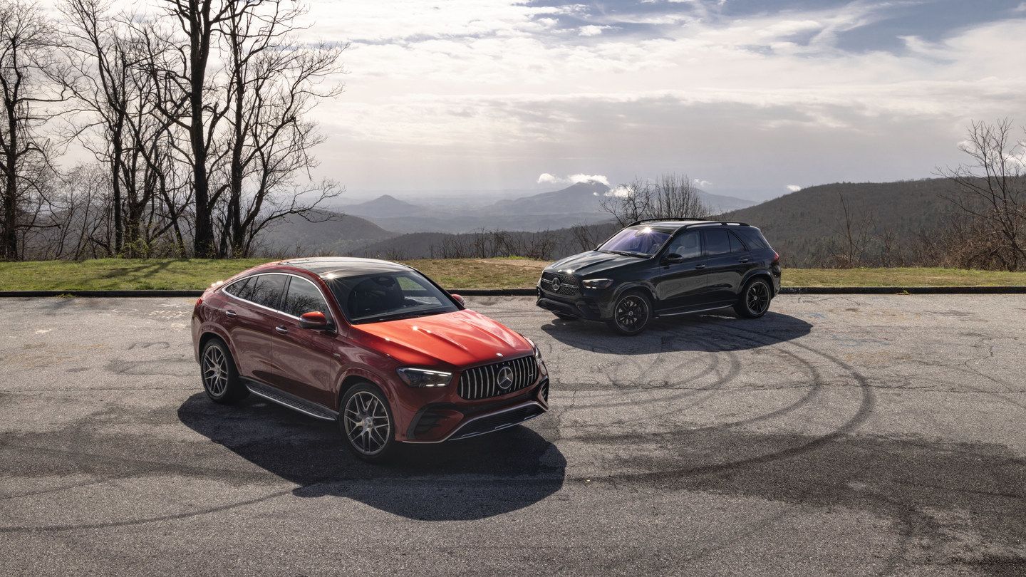 2026 Mercedes-Benz GLE-Class - front and side views of two 2026 Mercedes-Benz GLE-Class SUVs, one red and one black, parked on a mountain scenic overlook - Mercedes-Benz Brampton - New car dealership in Brampton, Ontario
