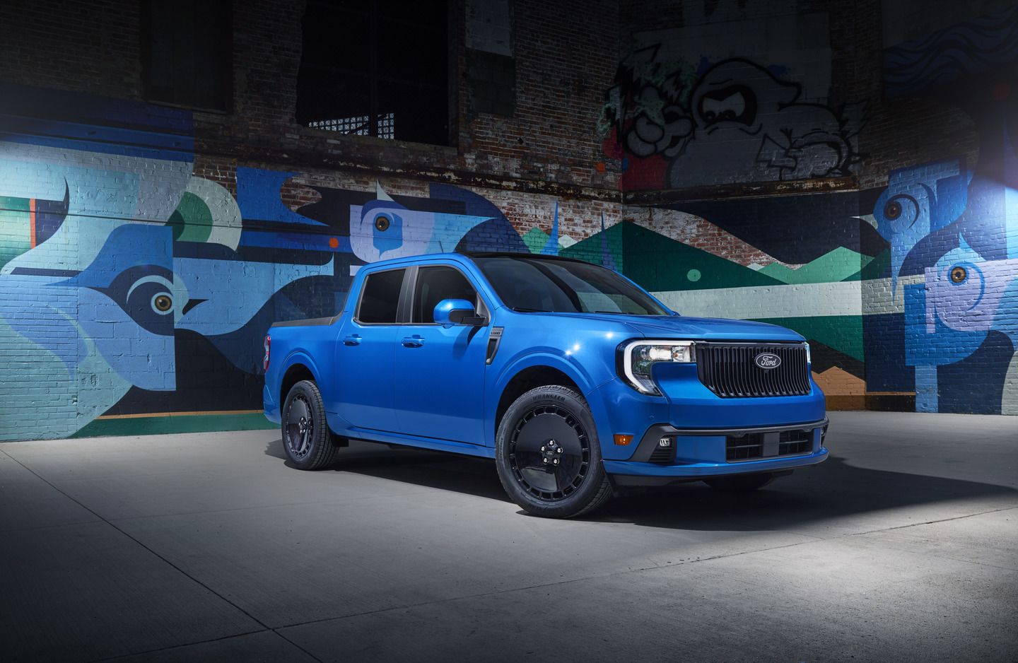 2026 Ford Maverick - a blue 2026 Ford Maverick parked in front of a colorful graffiti wall - Mayfield Ford - Ford new car dealership in Brampton, Ontario
