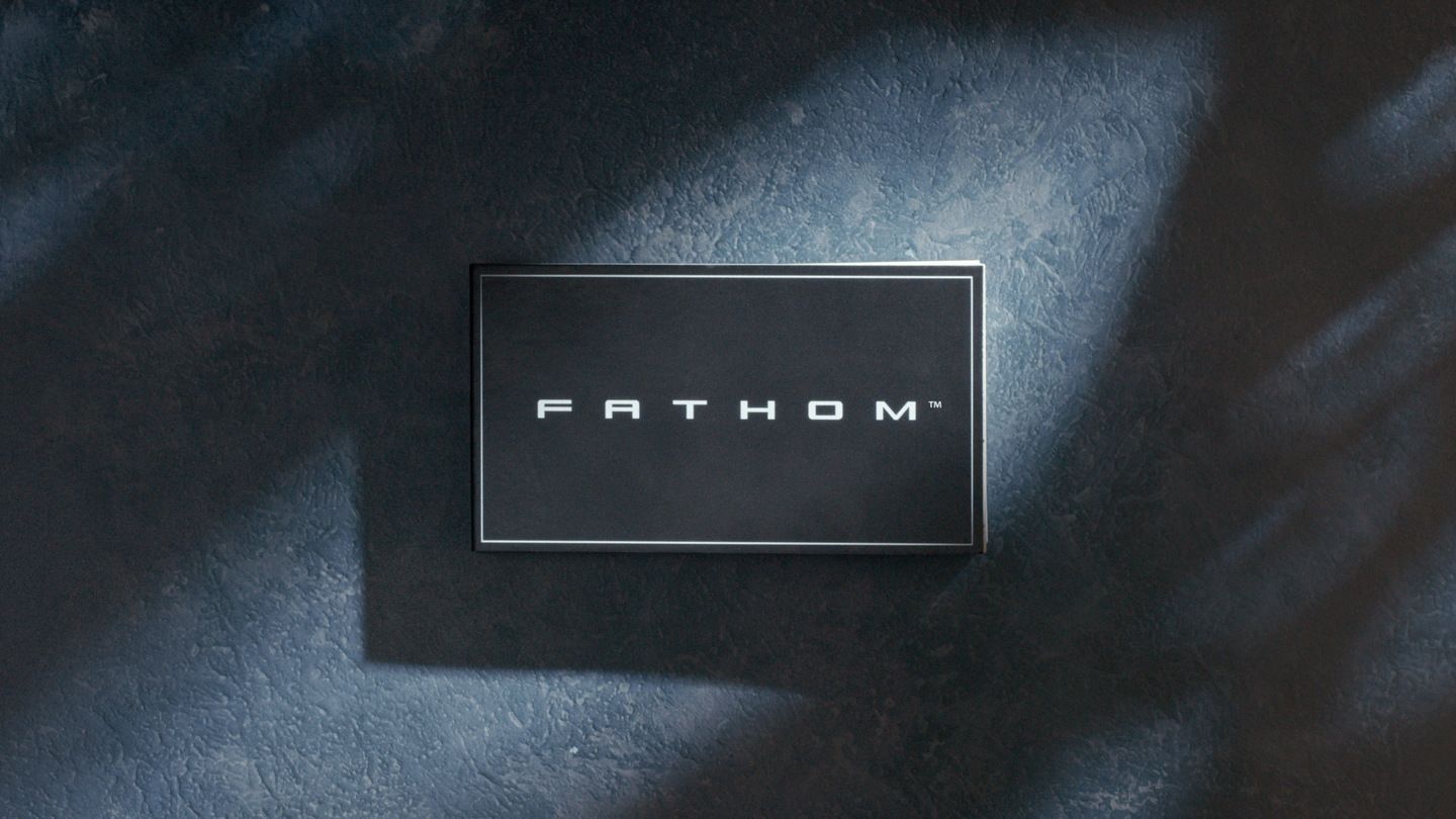 2028 Ford Fathom - close-up of a black rectangular FATHOM badge on a textured background - Bayfield Ford - Ford car dealership in Barrie, ON