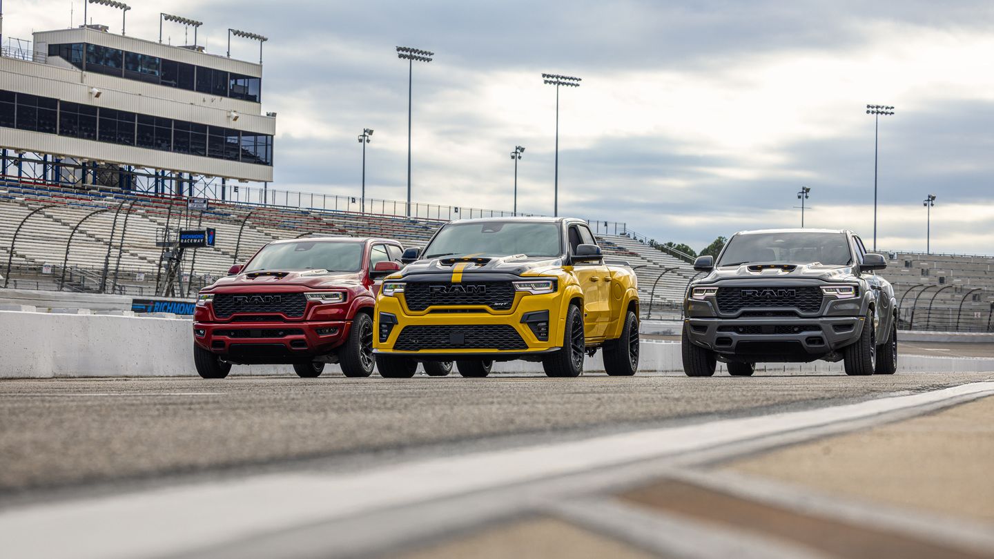2027 Ram 1500 Rumble Bee - front view of three 2027 Ram 1500 Rumble Bee trucks lined up on a racetrack - Cooksville Dodge - Ram car dealership in Mississauga, Ontario