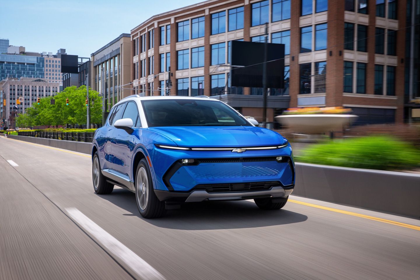 2026 Chevrolet Equinox EV - front three-quarter view of a blue 2026 Chevrolet Equinox EV driving on a city street - Humberview Chevrolet, Buick, GMC - Chevrolet new car dealership in Toronto, Ontario