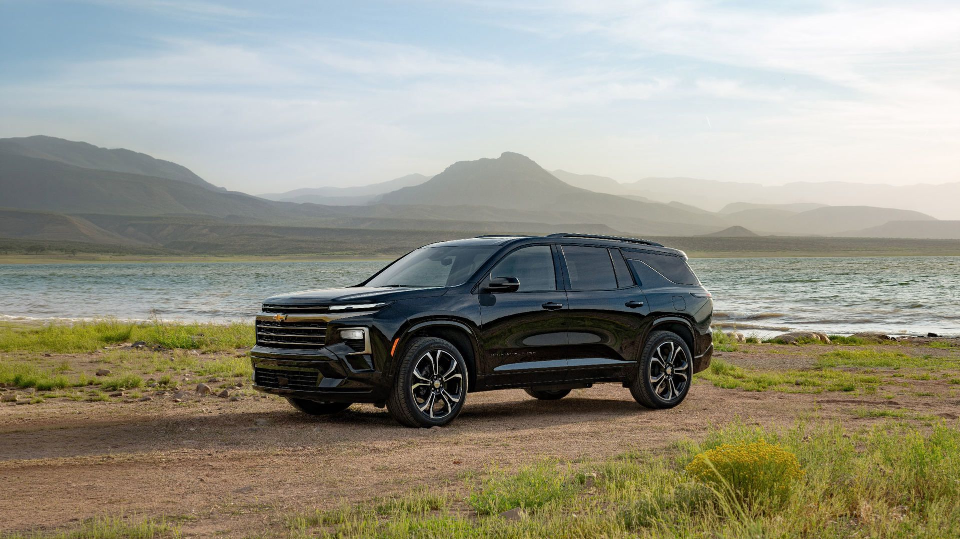 2027 Chevrolet Traverse - front three-quarter view of a black 2027 Chevrolet Traverse High Country parked by a scenic lake - City Chevrolet, Buick, GMC - New car dealership in Toronto, Ontario