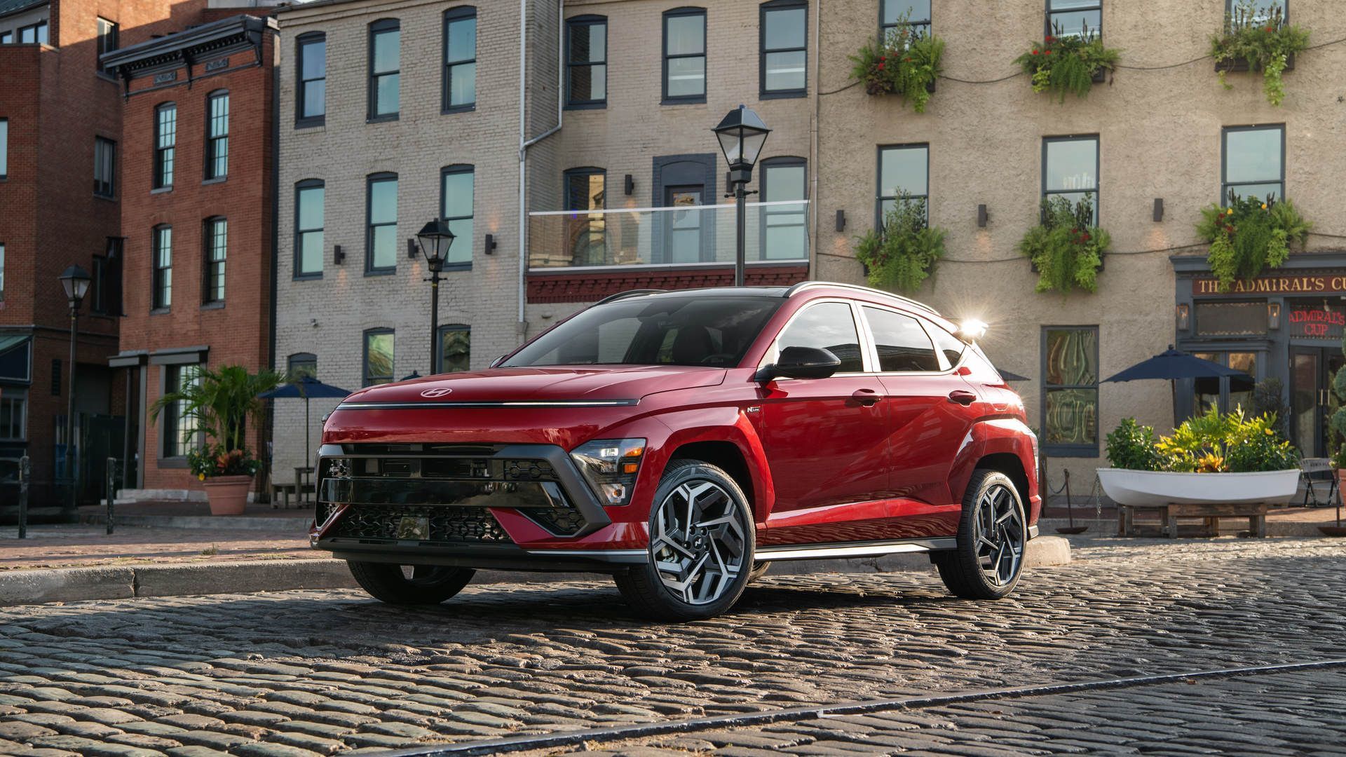 2027 Hyundai Kona - front-angle view of the vehicle on a cobblestone street - Cooksville Hyundai - New car dealership in Mississauga, Ontario