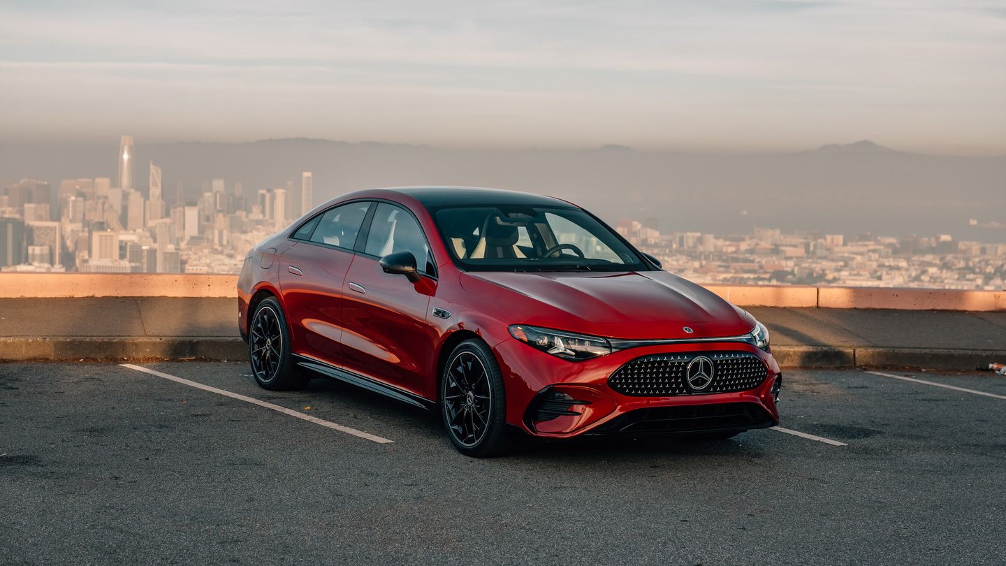 2027 Mercedes-Benz CLA - front three-quarter view of a red 2027 Mercedes-Benz CLA parked with a city skyline in the background - Mercedes-Benz Brampton - Mercedes-Benz car dealership in Brampton, Ontario